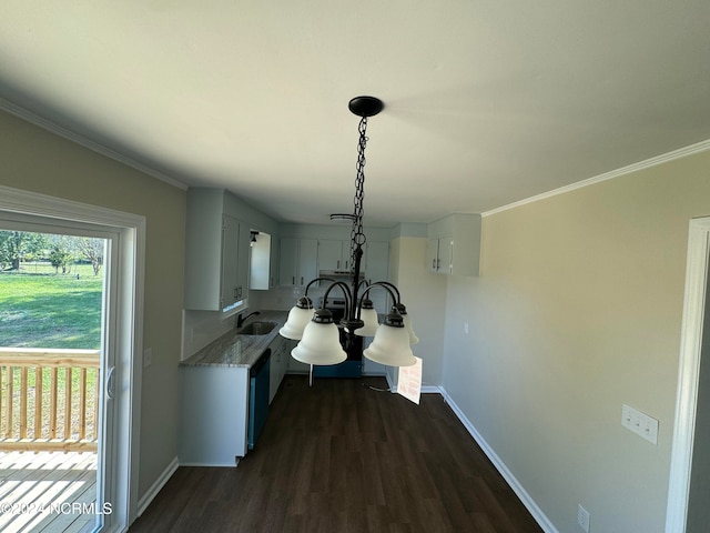 kitchen featuring sink, dark hardwood / wood-style flooring, hanging light fixtures, white cabinets, and crown molding