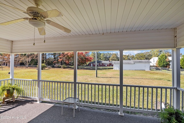 unfurnished sunroom featuring ceiling fan and wooden ceiling