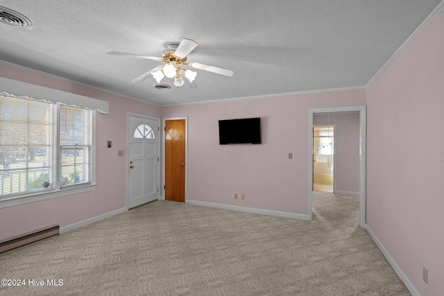 carpeted foyer entrance with ceiling fan, crown molding, a textured ceiling, and baseboard heating