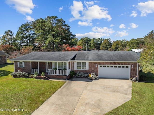 ranch-style house featuring covered porch, a front lawn, and a garage