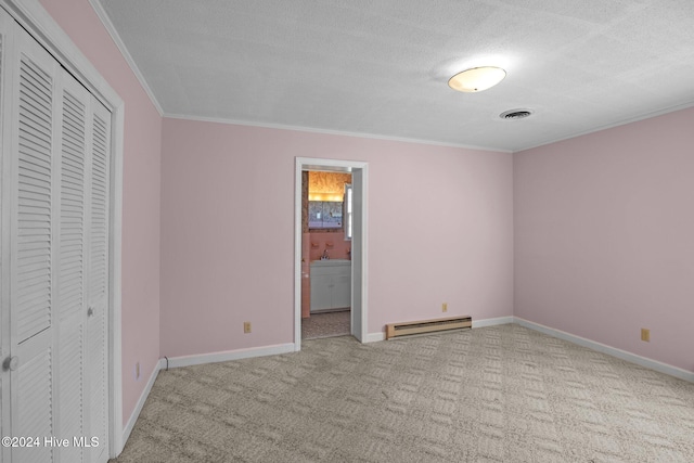 unfurnished bedroom featuring connected bathroom, ornamental molding, light colored carpet, a baseboard radiator, and a textured ceiling