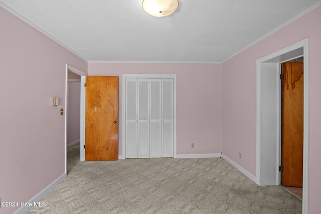 unfurnished bedroom featuring crown molding and light carpet