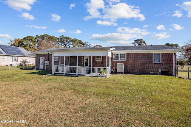 back of house with a porch and a lawn