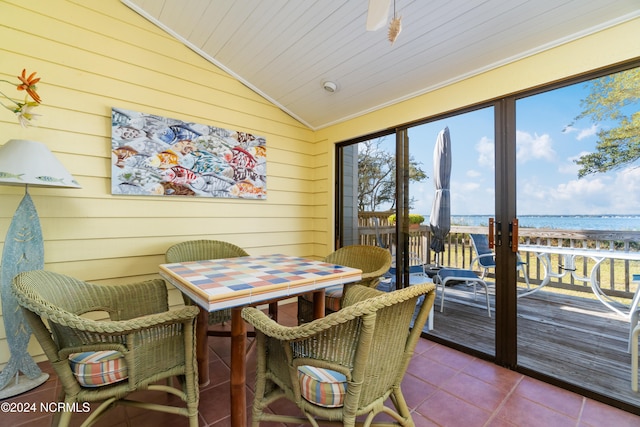 sunroom featuring a water view, wooden ceiling, and vaulted ceiling