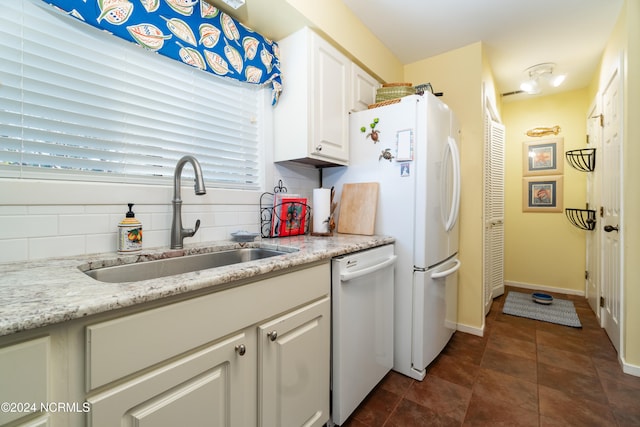 kitchen featuring white appliances, tasteful backsplash, sink, white cabinets, and light stone counters