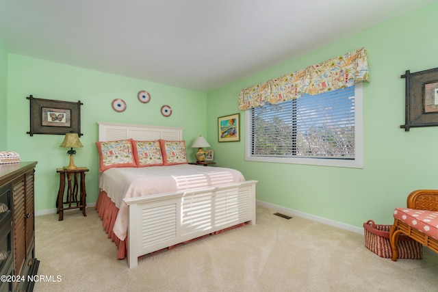carpeted bedroom with baseboards and visible vents