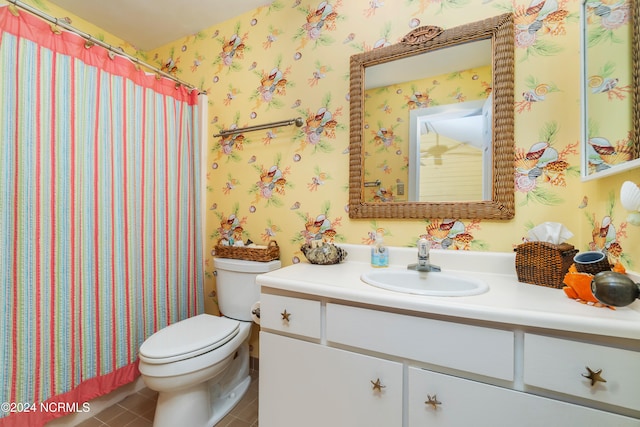 bathroom featuring vanity, toilet, and tile patterned flooring