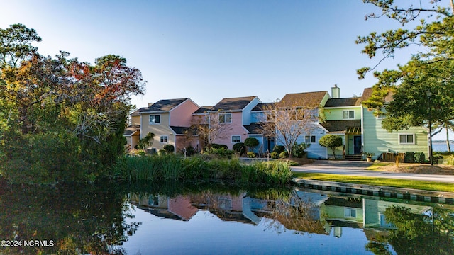 exterior space featuring a residential view and a water view
