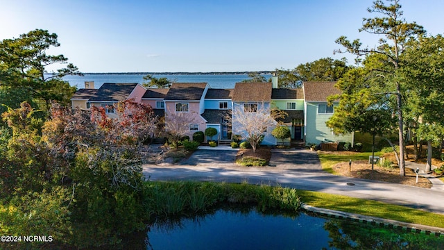view of front of home with a water view and a chimney