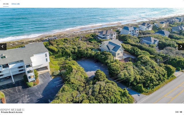 bird's eye view featuring a beach view and a water view