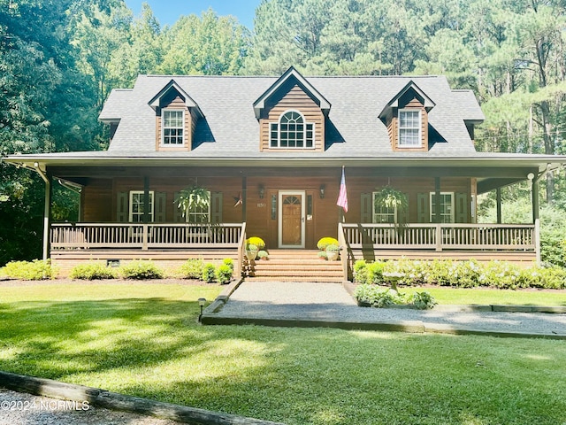 view of front of property with a porch and a front lawn