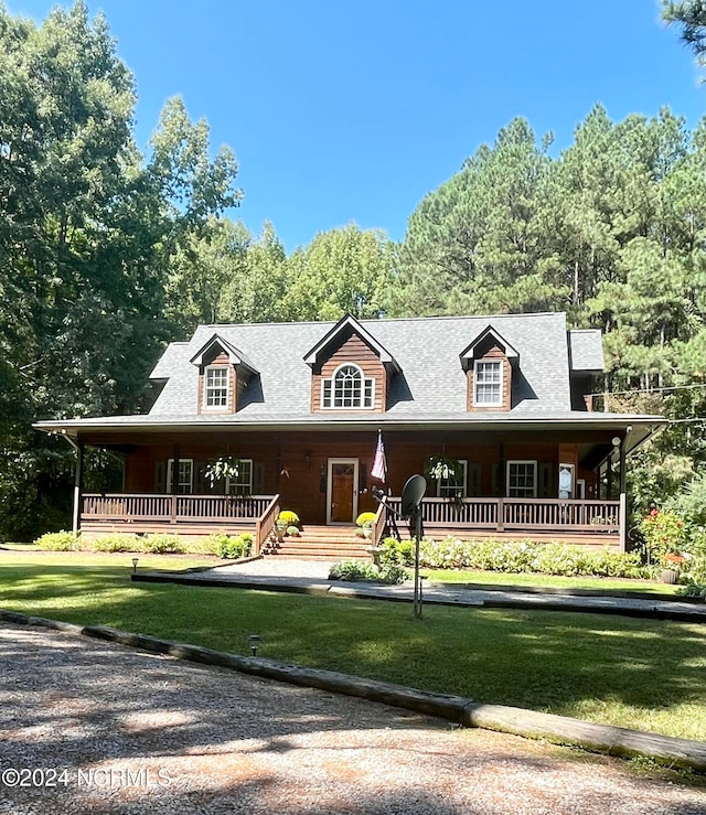 view of front of property with covered porch and a front lawn