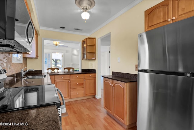 kitchen with visible vents, dark stone countertops, stainless steel appliances, open shelves, and a sink