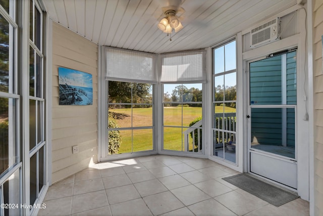 unfurnished sunroom with wood ceiling and a ceiling fan