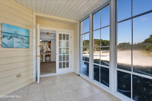 unfurnished sunroom with wood ceiling