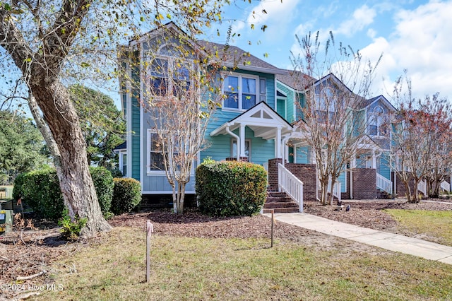 view of front of home with a front lawn and a porch