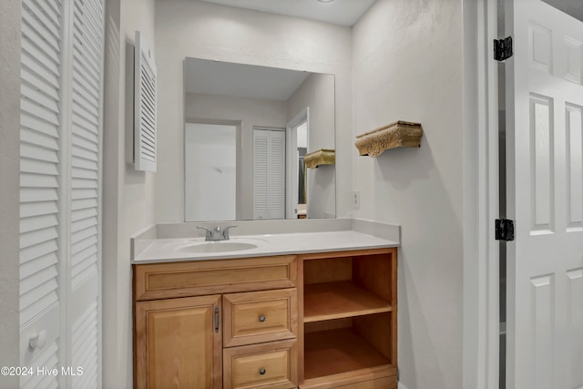 bathroom with a closet and vanity