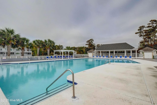 community pool featuring a patio, fence, and a pergola