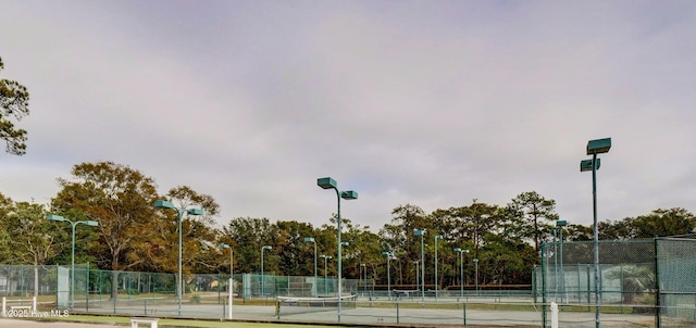 view of sport court featuring fence