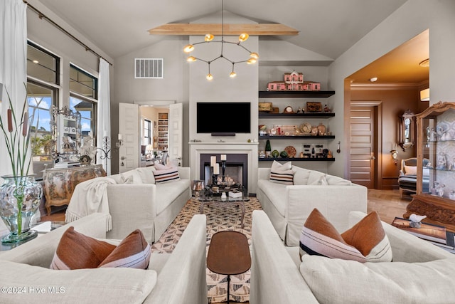 living room with ornamental molding, a chandelier, and vaulted ceiling with beams