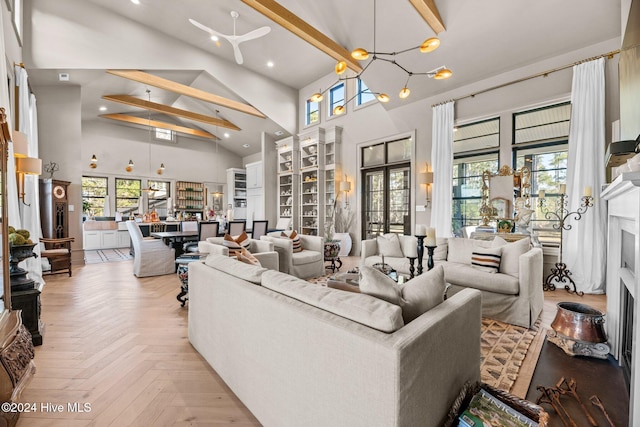 living room featuring beam ceiling, light parquet flooring, a chandelier, and high vaulted ceiling