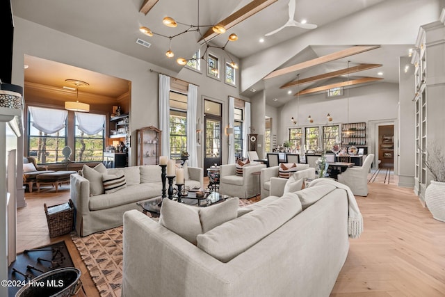 living room with crown molding, light parquet flooring, and high vaulted ceiling