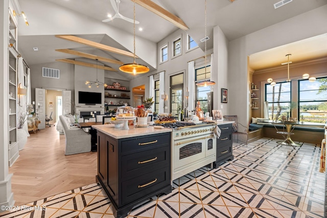 kitchen featuring light parquet floors, ornamental molding, decorative light fixtures, a center island, and double oven range