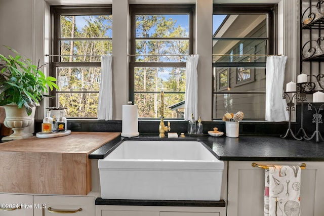 interior space featuring sink and white cabinets