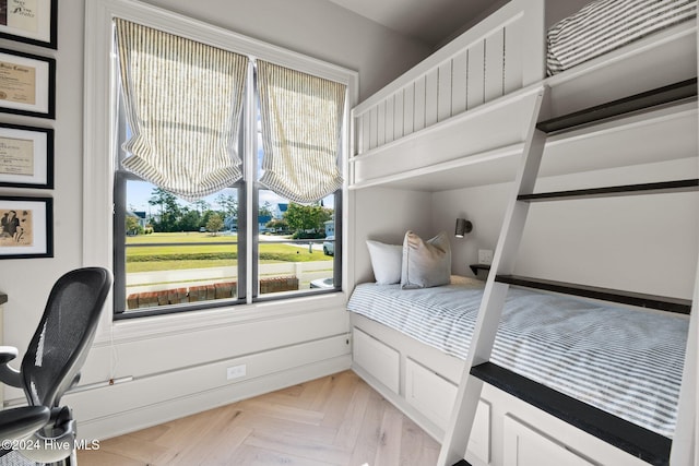 bedroom with light parquet flooring