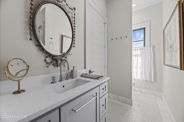 bathroom with vanity, toilet, and tile patterned flooring