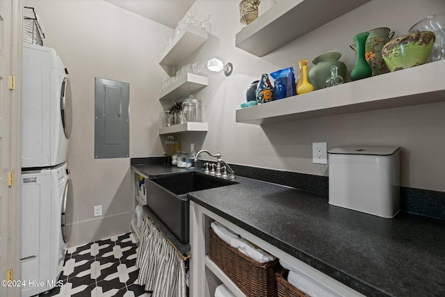 kitchen with sink, electric panel, and stacked washer and dryer