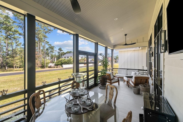 sunroom / solarium featuring ceiling fan