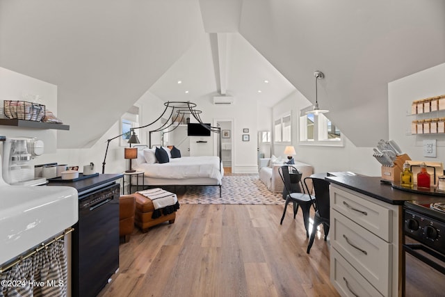 bedroom featuring lofted ceiling and light wood-type flooring