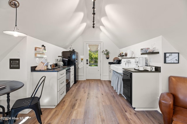 kitchen with black appliances, light hardwood / wood-style floors, decorative light fixtures, vaulted ceiling, and white cabinets