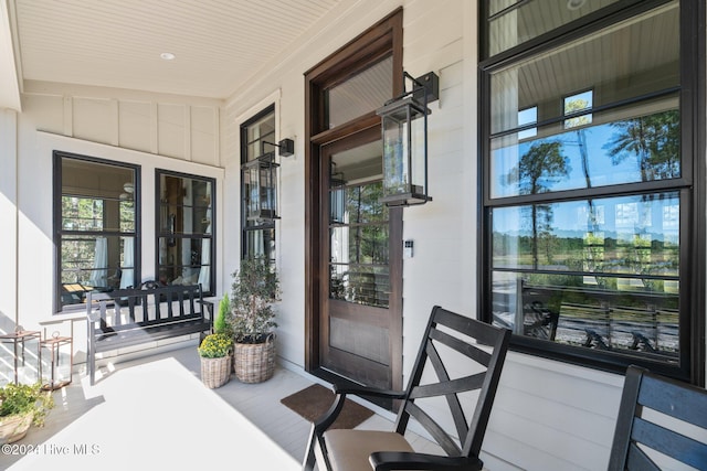 view of exterior entry featuring covered porch