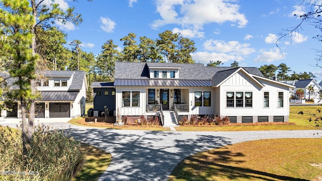 modern farmhouse style home featuring a porch and a front lawn