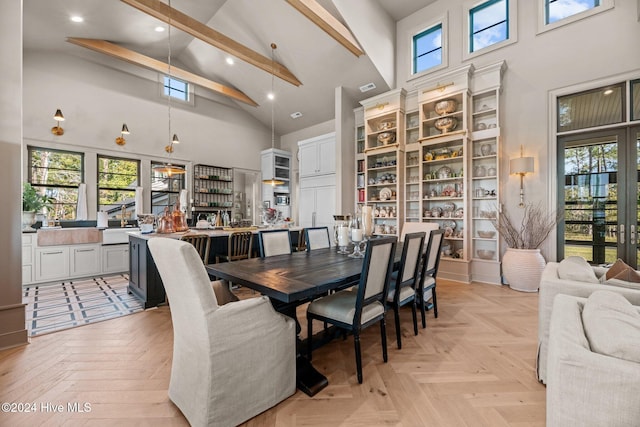 dining room with light parquet flooring, beam ceiling, and high vaulted ceiling