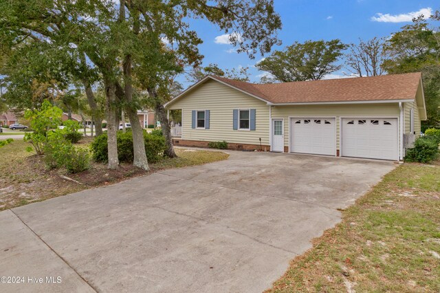 single story home with covered porch and a front yard