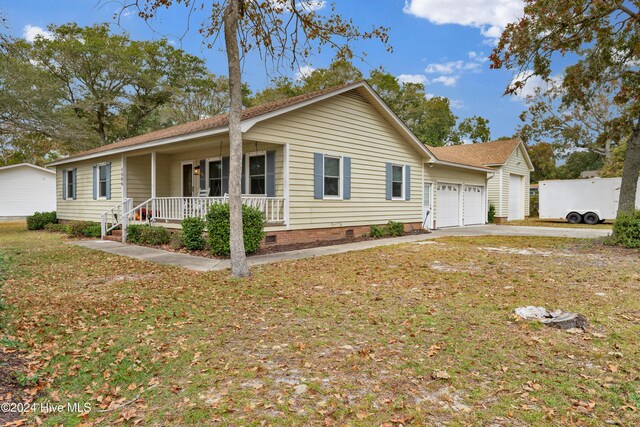 ranch-style home with covered porch and a yard