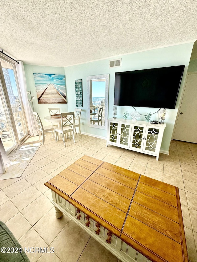 unfurnished living room with a textured ceiling and tile patterned flooring