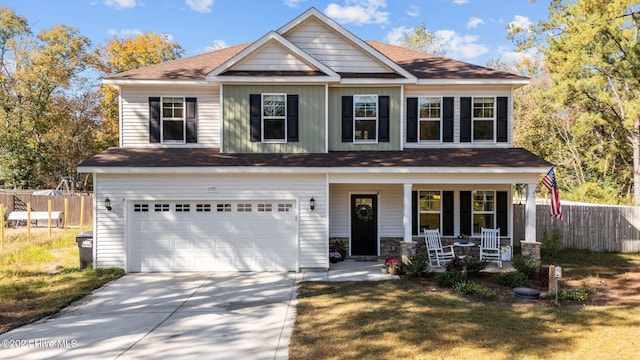 craftsman-style house featuring covered porch, a front lawn, and a garage