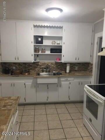 kitchen with white electric range oven and white cabinetry