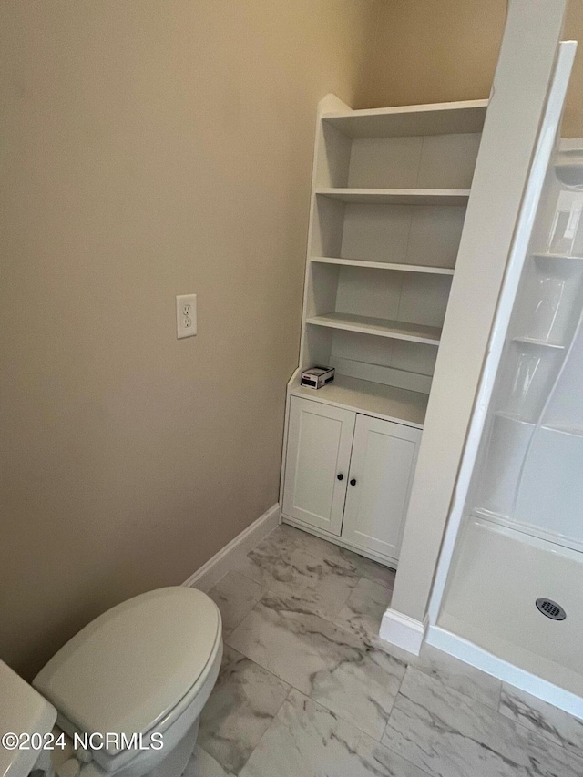 bathroom featuring toilet and walk in shower