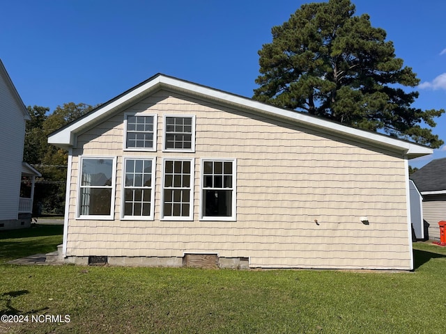 view of side of home with a lawn