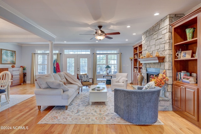 living room featuring crown molding, light wood-type flooring, and ceiling fan