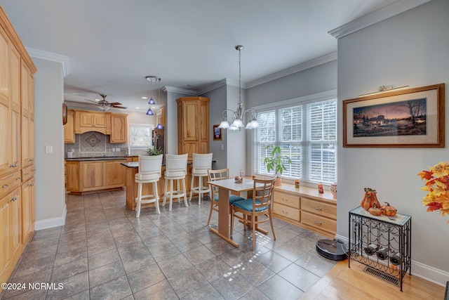 tiled dining room with crown molding and ceiling fan with notable chandelier