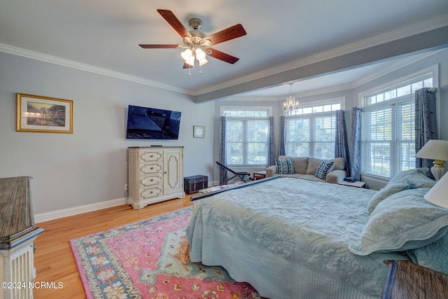 bedroom with multiple windows, ornamental molding, wood-type flooring, and ceiling fan with notable chandelier