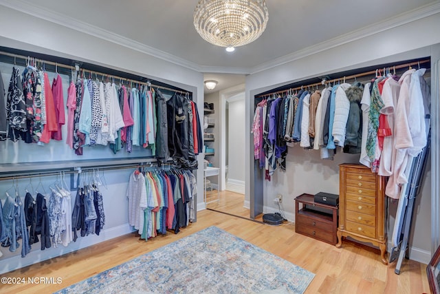 spacious closet featuring a notable chandelier and hardwood / wood-style flooring