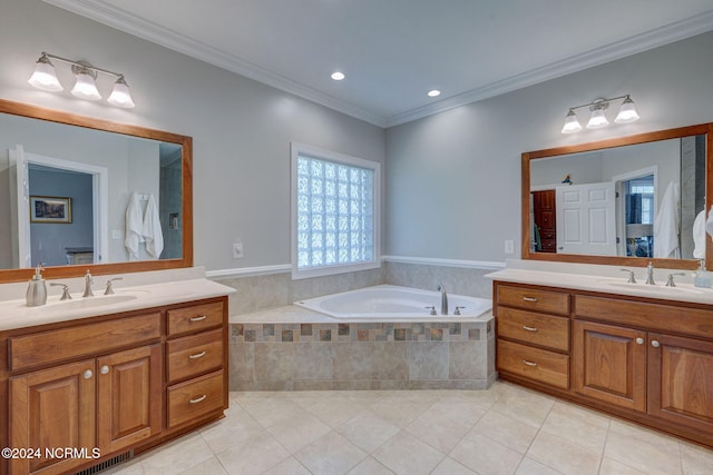 bathroom featuring vanity, crown molding, tile patterned flooring, and tiled tub