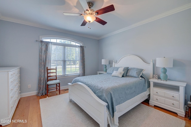 bedroom with crown molding, light hardwood / wood-style flooring, and ceiling fan